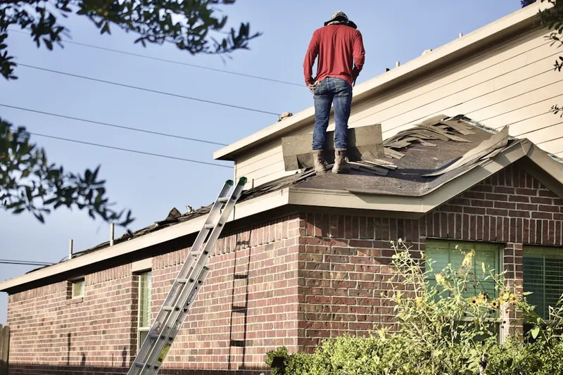 Professional roofer working on a residential roof in Parish